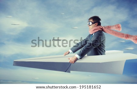 Businessman flying on paper plane