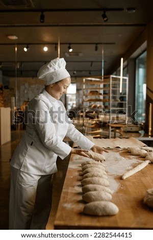 Similar – Foto Bild Bäcker formt Brot in der Küche