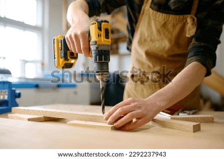 Similar – Image, Stock Photo young handyman installing wooden floor