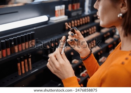 Similar – Image, Stock Photo A woman consumes a white line in powder form with a rolled banknote through her nose