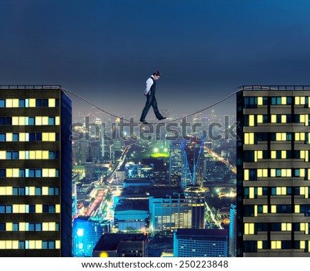 Businessman thinking going the tightrope