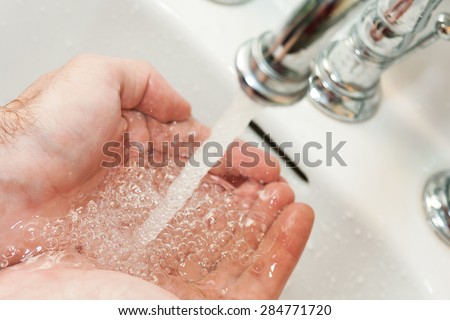 Hands under the stream of water