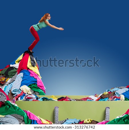 Woman flying to the heap of clothes