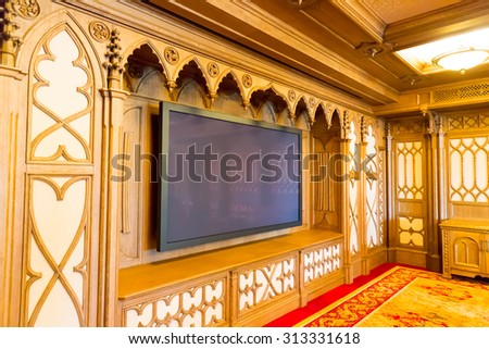 Novi Petrivtsi, Ukraine - May 27, 2015 Mezhigirya residence of ex-president of Ukraine Yanukovich. Modern home theater room interior with big TV set
