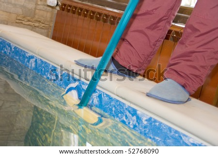 Cleaning a pool. Pool guy