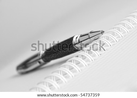 Open writing book with pen