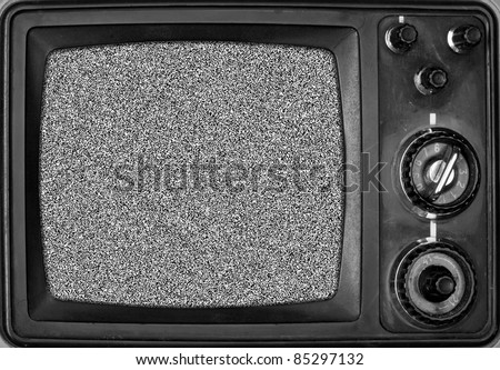 Vintage TV with noise on screen. In B/W