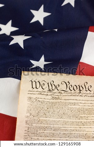US Constitution against an american flag.