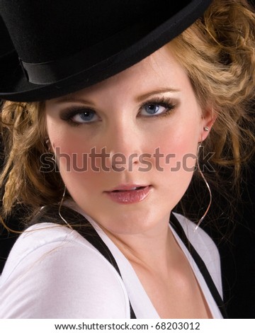 woman wearing a white tee shirt, suspenders and black bowler hat