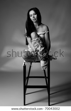 Black and white shoot of girl sits on the chair studio shoot