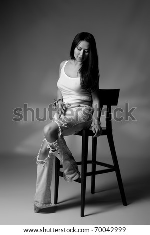 Black and white shoot of girl sits on the chair studio shoot
