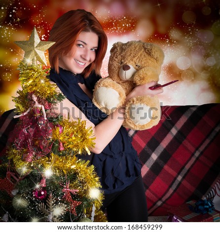 Christmas tree.Night New Year.Woman with teddybear