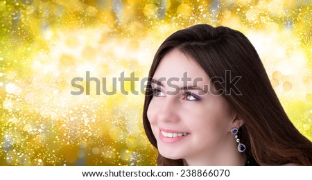 Christmas.Beauty, people and health concept - beautiful young woman face over golden abstract background