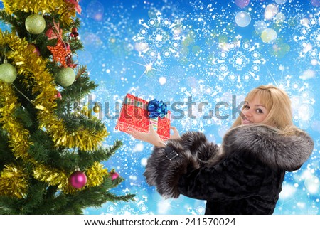 Woman with gift and new year tree
