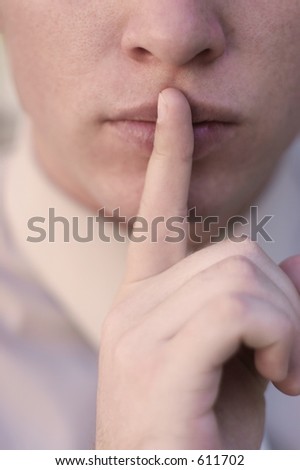 businessman with finger to lips