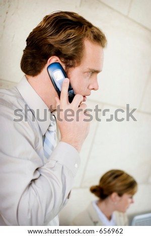 Business man makes a call on his cell phone