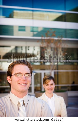 businessman and woman looking in the same direction