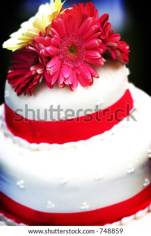 white wedding cake with pink trim and white and pink flowers