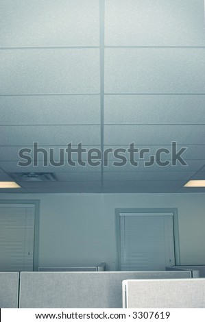 Open office space room with a line going across the ceiling on the top and office space cubicles in the foreground