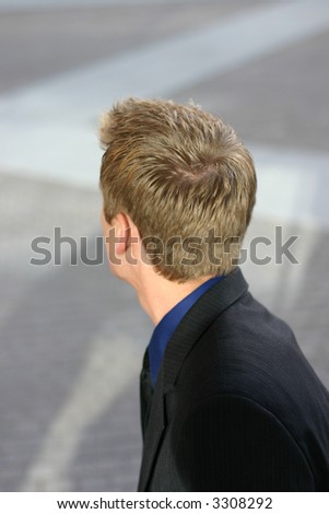 Businessman looking back over his shoulder and you see the back of his head