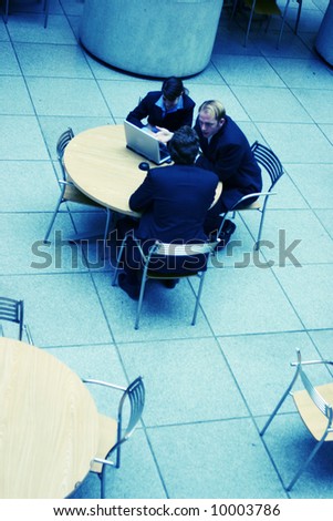 small group of business people conversing at table