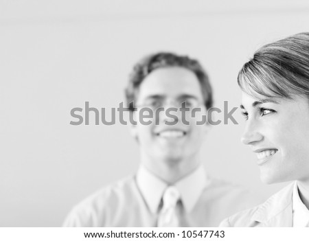 head and shoulder shot of smiling businessman and businesswoman
