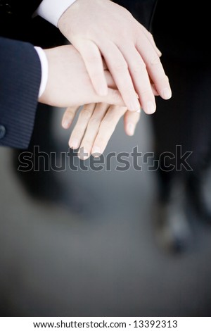 close up view of three white hands on top of each other