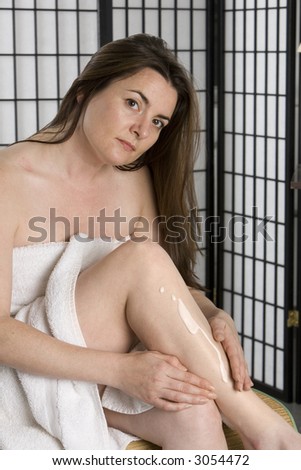 Woman using skin cream after a bath