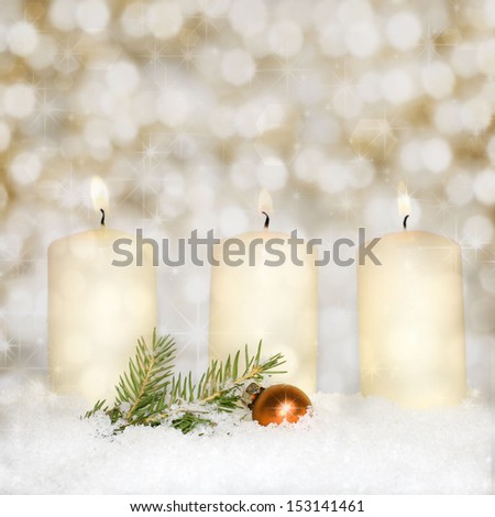 Brightly lit candles in snow