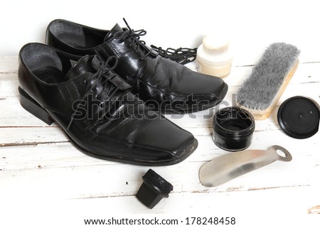 shoe care equipment and formal black shoe on white background
