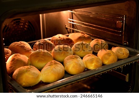 Baked cakes on a tray in the oven