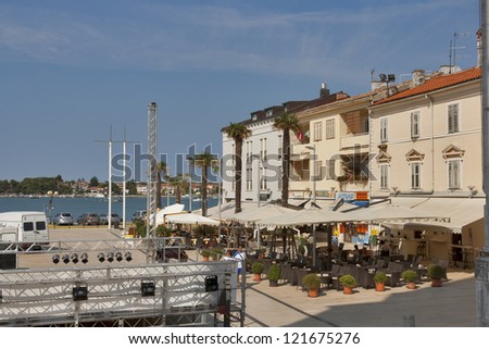 UMAG, CROATIA - AUGUST 15: Workers install show scene on the central square of mediterranean town on August 15, 2012 in Umag, Croatia. Umag hosts the yearly Open ATP tennis tournament on clay courts.