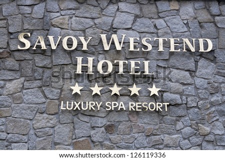 KARLOVY VARY, CZECH REPUBLIC - NOVEMBER 13: Luxury spa Savoy Westend Hotel sign on stone wall on November 13, 2012 in Karlovy Vary, Czech Republic. Hotel underwent thorough reconstruction in 2004-5.