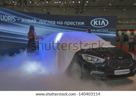 KIEV, UKRAINE - MAY 29: Presenters work at presentation of Korean car model KIA Quoris at SIA\' 2013 Kyiv International Motor Show in International Exhibition Centre on May 29, 2013 in Kiev, Ukraine.