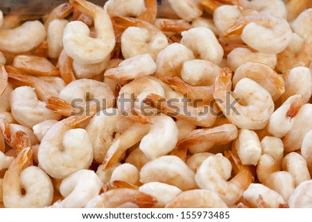 peeled frozen shrimps with tails for sale closeup