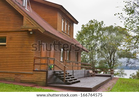 country wooden house in the forest close to lake