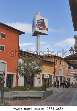 MUGELLO, ITALY - SEPTEMBER 11, 2014: People walk along McArthurGlen Designer Outlet Barberino shops situated in 30 minutes from Florence. McArthurGlen Group opened its first designer outlet in 1995.