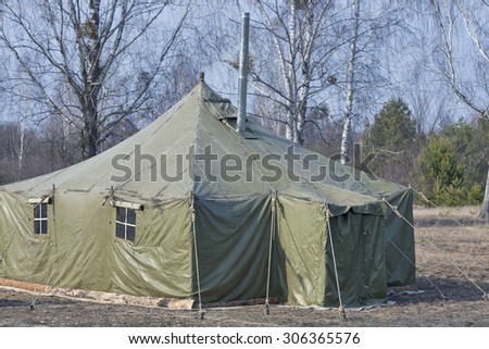 big old army expedition tent in the autumn forest