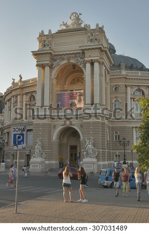 ODESSA, UKRAINE - JULY 15, 2014: People walk and make photos in front of National Academic Opera and Ballet Theater. It is generally regarded as the second most important Opera House after Vienna.