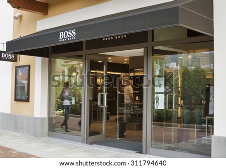 MUGELLO, ITALY - SEPTEMBER 11, 2014: People visit Hugo Boss store in McArthurGlen Designer Outlet Barberino close to Florence. Hugo Boss is a German luxury fashion and style house founded in 1924.