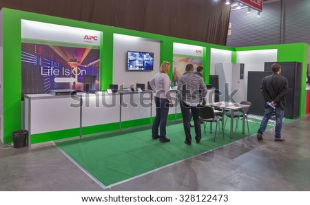 KIEV, UKRAINE - OCTOBER 11, 2015: People visit Schneider Electric, France electronics manufacturer booth during CEE 2015, the largest electronics trade show of Ukraine in ExpoPlaza Exhibition Center