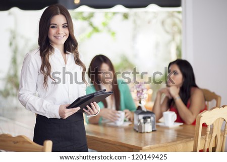 Happy female waitress loving her job and taking care of their customers