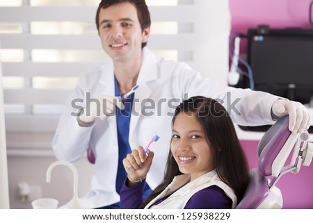 Happy latin teenage patient loves to brush her teeth