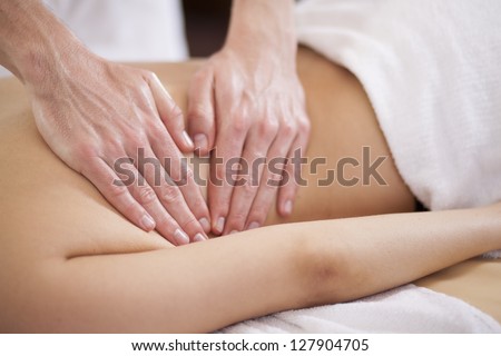 Closeup of the hands of a therapist giving a back massage