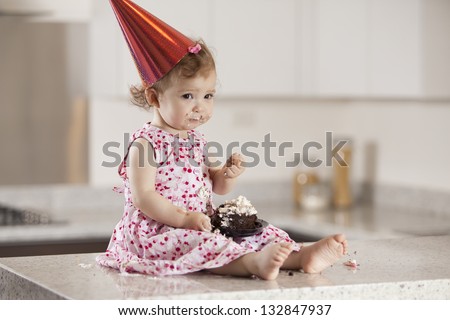 Sad birthday girl eating cake
