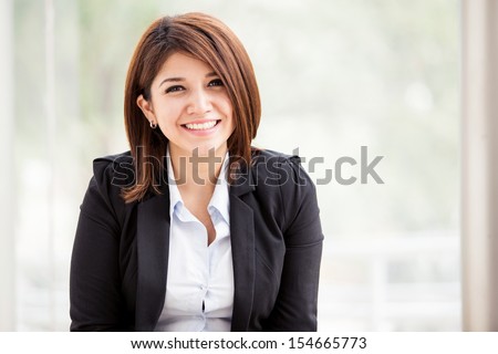 Portrait of a gorgeous young Hispanic - Asian female business school student smiling