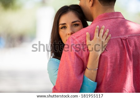 Portrait of a beautiful young woman hugging her husband. Lots of copy space