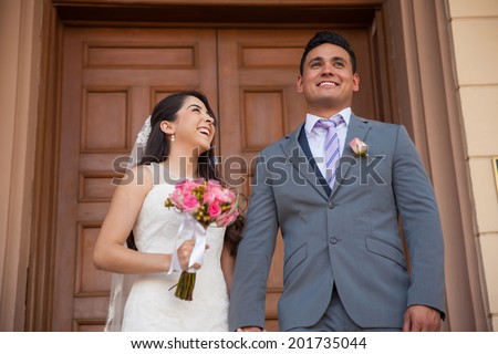 New husband and wife outside of a church on their wedding day