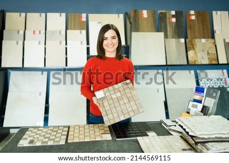 Portrait of a beautiful young woman at the store buying tiles for her new bathroom or redecorating her kitchen Imagine de stoc © 