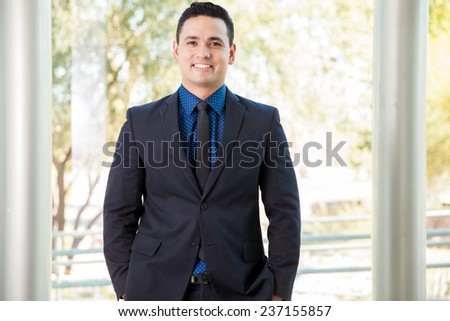 Portrait of a handsome young Hispanic businessman smiling at work